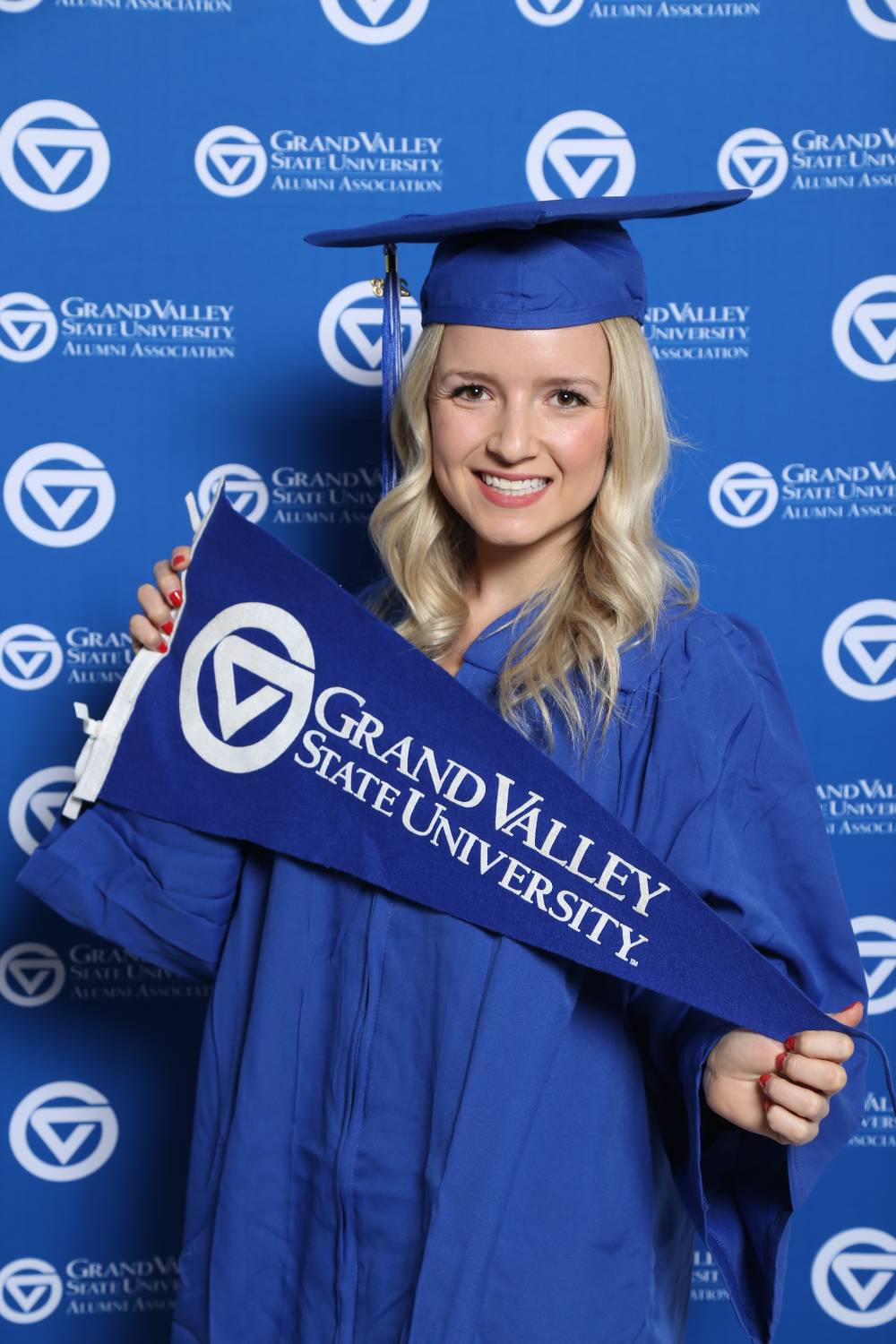 A future graduate poses with GV flag at Gradfest